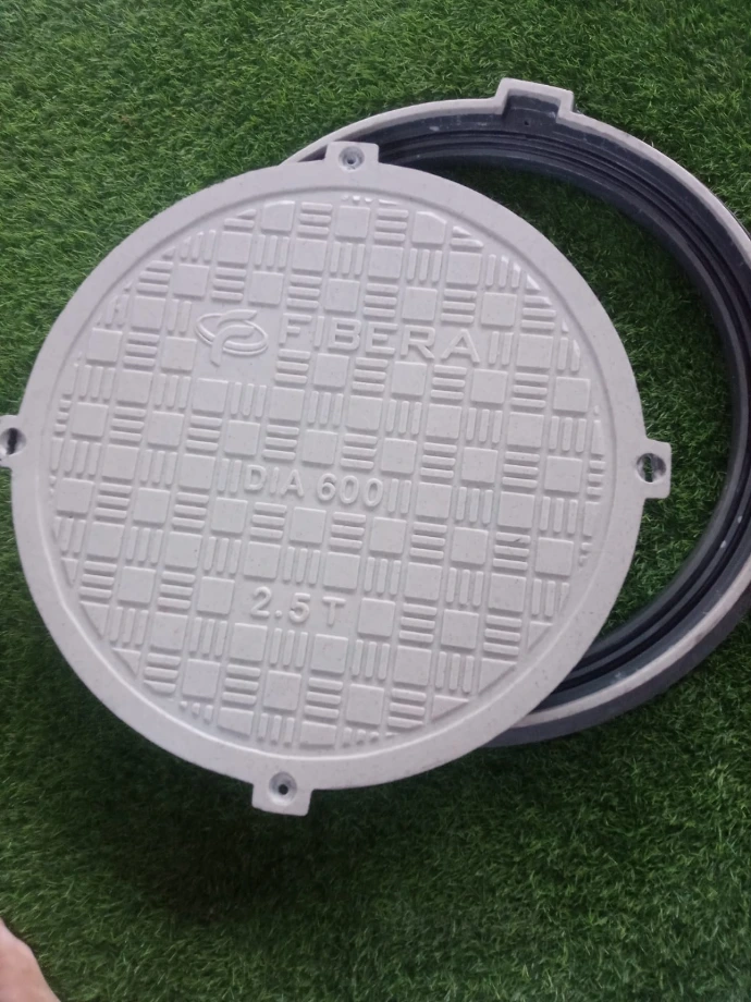 Circular composite sewer cover installed on ground