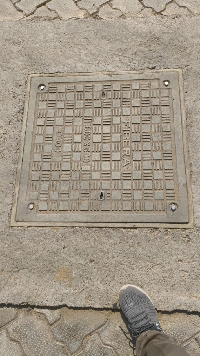 flush-installed anti-slip composite tank cover on paved ground.