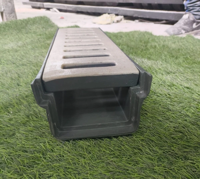 Rectangular FRP drainage cover installed along garden turf edge