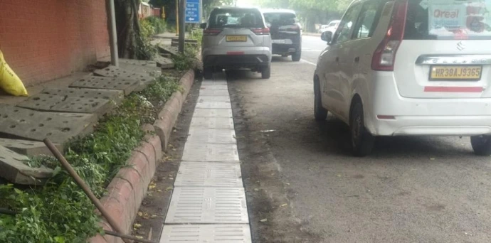 Heavy-duty FRP curb gully drainage cover installed along roadside pavement