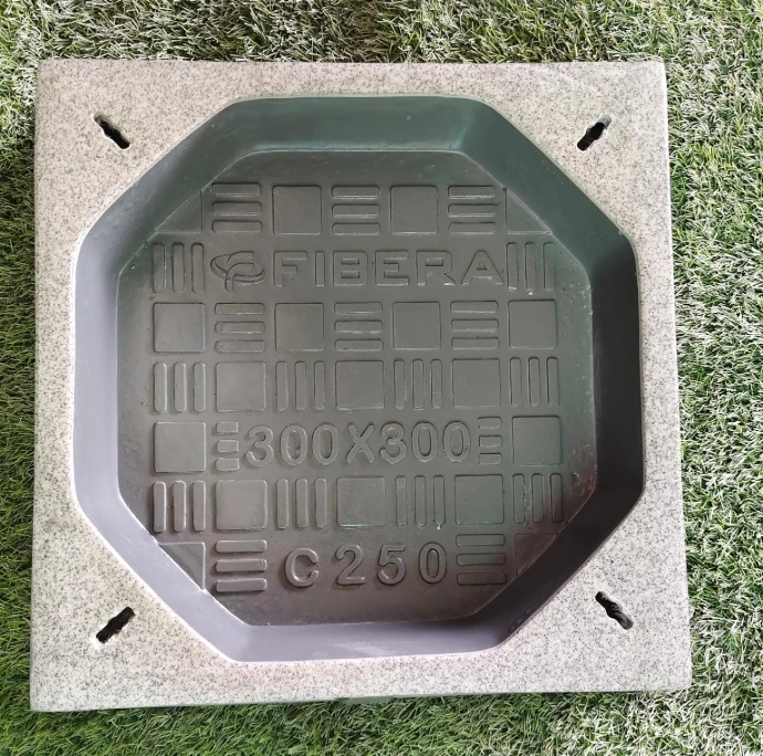 Square FRP recessed manhole cover with paver infill installed flush on stone patio