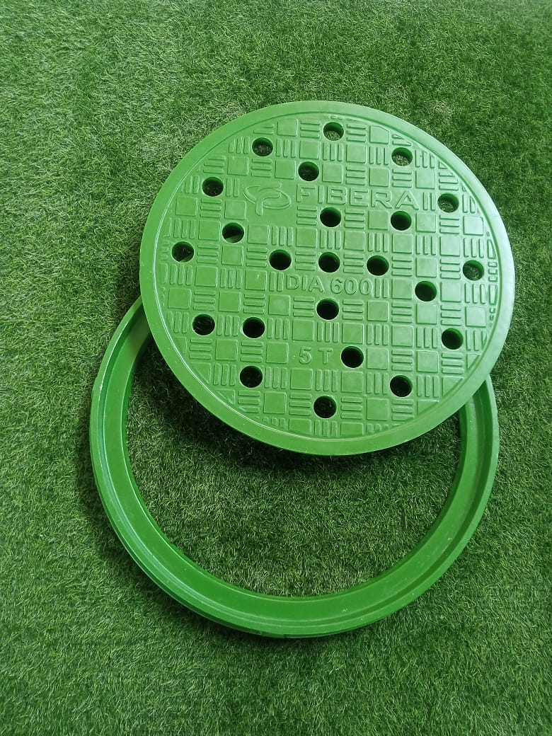 Round green FRP manhole cover with a patterned hole design.