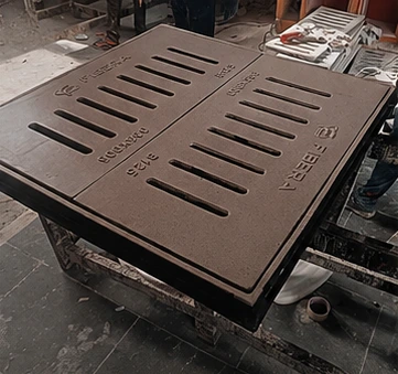 Square brown FRP manhole cover installed on outdoor paving.
