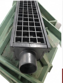 Square black FRP water gully grating installed over a drain pipe.