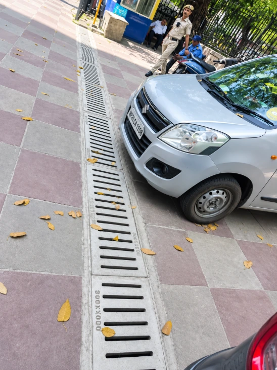 Grey FRP cover installed along a city street curb.